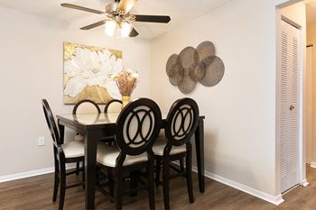 Spacious Dining Room with Ceiling Fan and Light and Hardwood Style Flooring